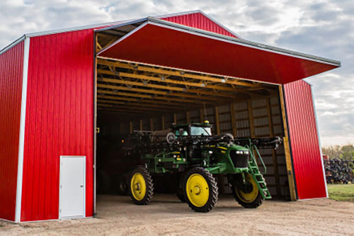 Bi-fold garage door on agricultural hangar